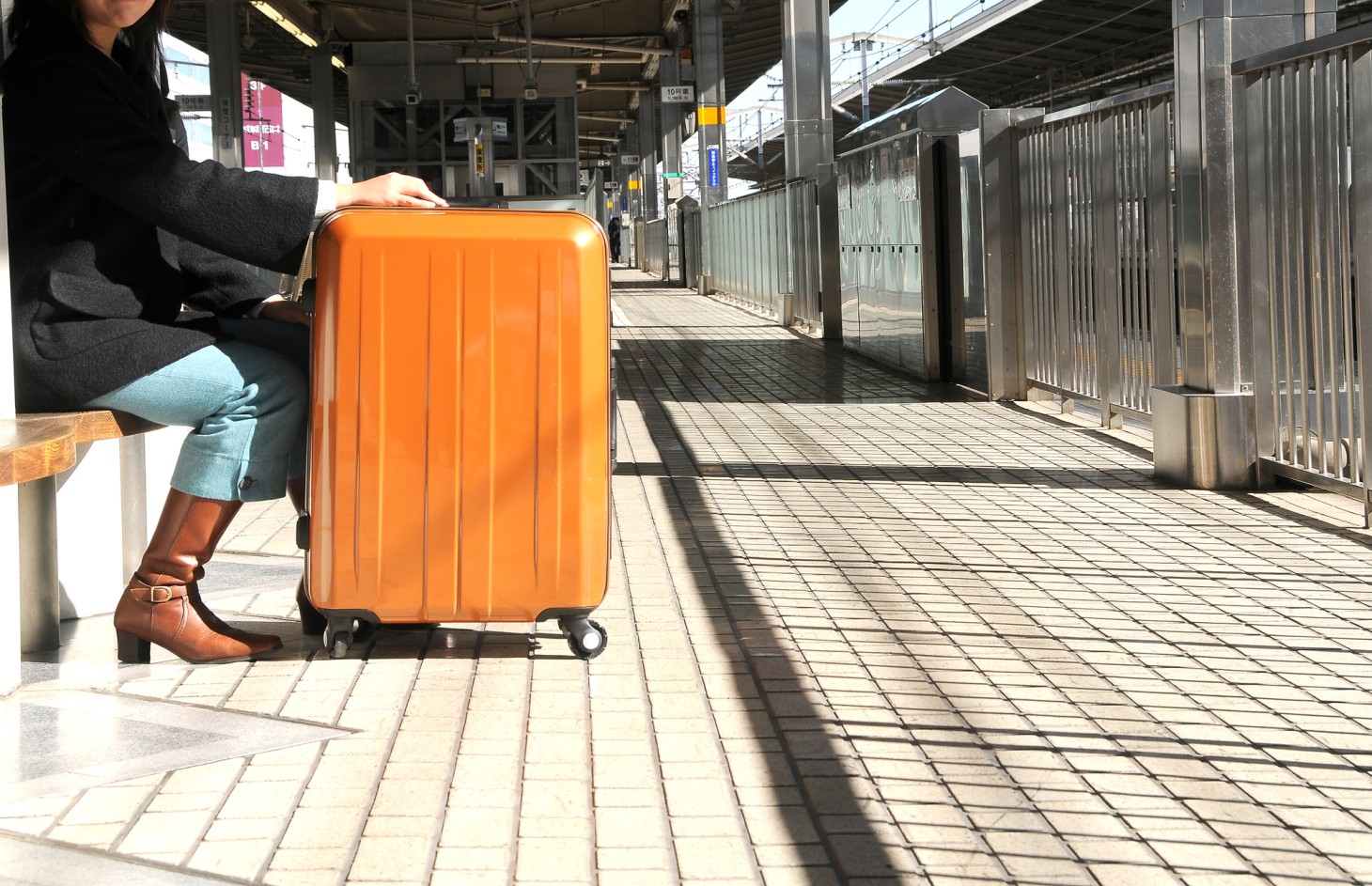 Travelers sitting on benches at the station.